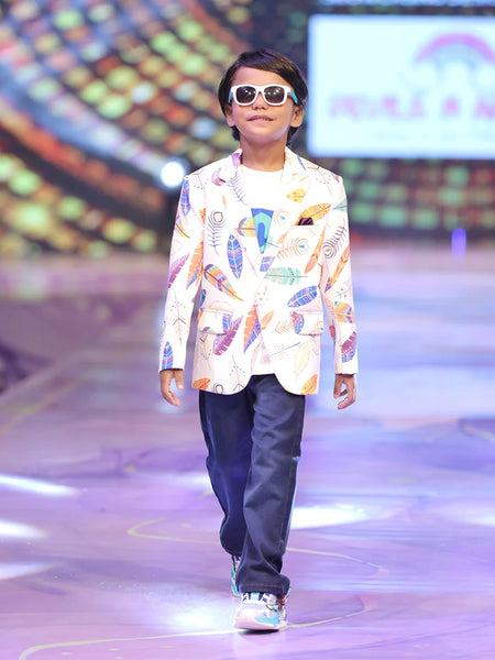 Child model walking on a fashion show runway wearing a colourful party blazer.