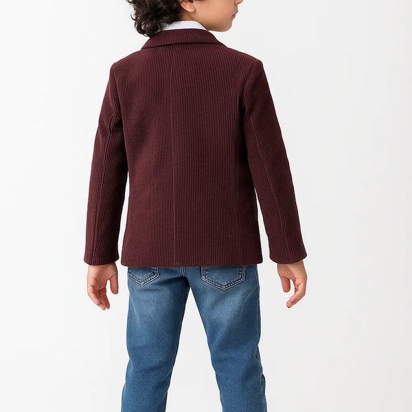 Child wearing a burgundy jacket and blue jeans on a white background