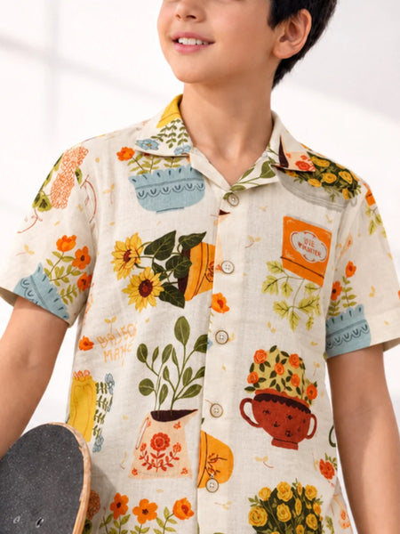 Child wearing a floral patterned shirt with a white background