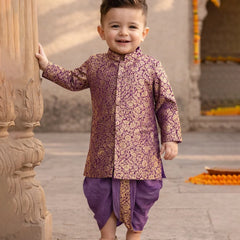 Child wearing a traditional outfit standing outdoors near architectural elements.