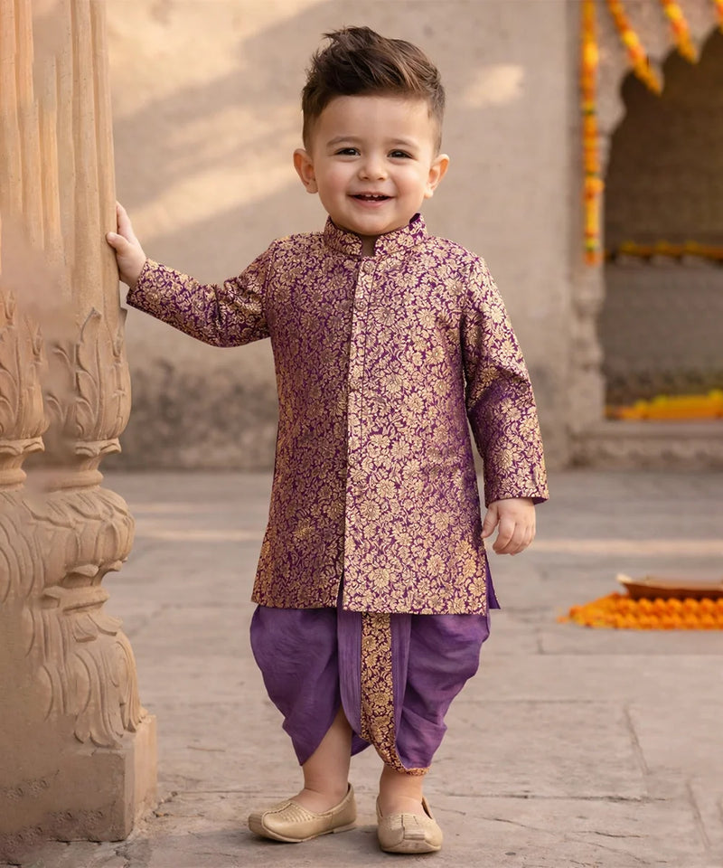 Child wearing a traditional outfit standing outdoors near architectural elements.