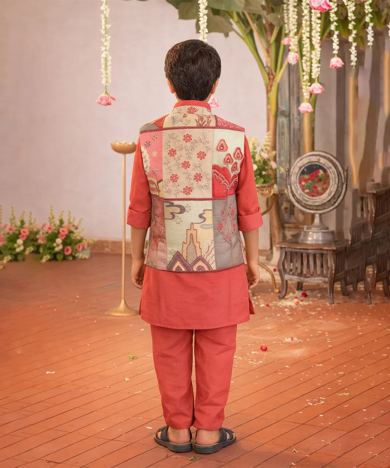 Person wearing a traditional outfit with a floral vest in an indoor setting with decorative elements.