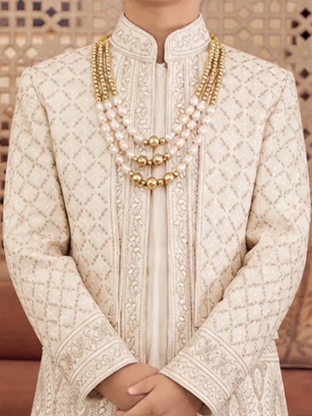 Close-up of boys' cream sherwani with mandarin collar