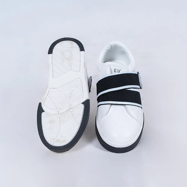 Close-up of trendy boys' white sneakers with black bands and easy-fit design, Jaipur