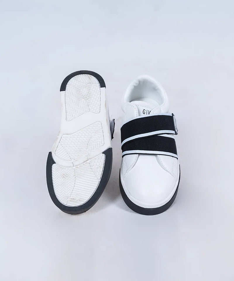 Close-up of trendy boys' white sneakers with black bands and easy-fit design, Jaipur