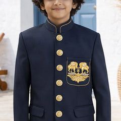 Child wearing a navy blue traditional outfit with gold buttons and embroidery.