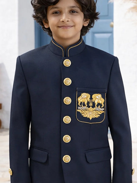 Child wearing a navy blue traditional outfit with gold buttons and embroidery.