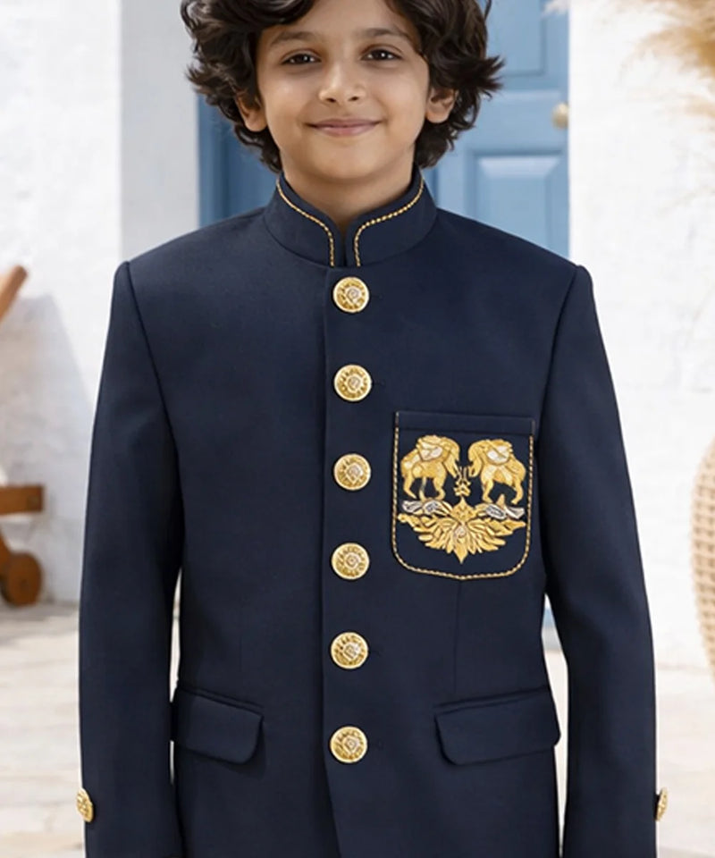Child wearing a navy blue traditional outfit with gold buttons and embroidery.