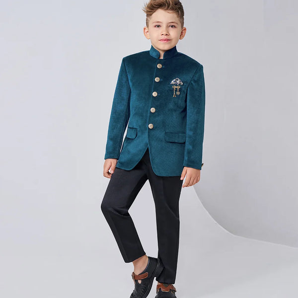 Child wearing a teal blazer with buttons and black pants on a white background