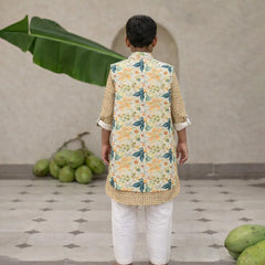 Child wearing a floral kurta with a vest in a home setting