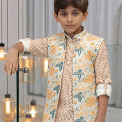 Young boy wearing a floral outfit in an indoor setting with decorative lights.