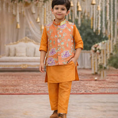 Child wearing an orange traditional outfit with a floral vest in a decorated setting