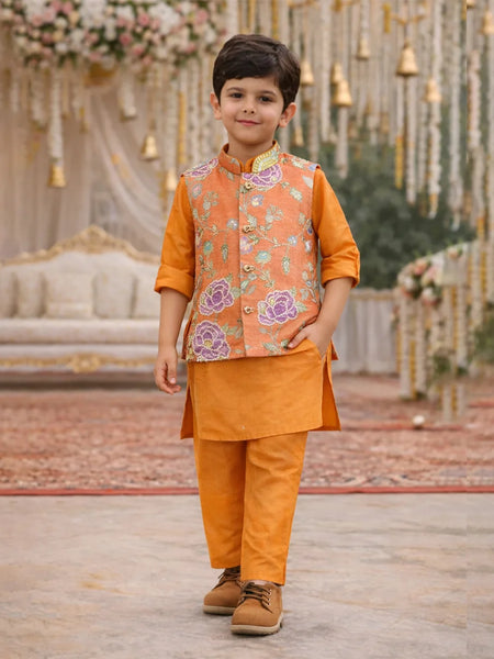 Child wearing an orange traditional outfit with a floral vest in a decorated setting