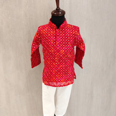 Red patterned shirt on a mannequin against a beige background