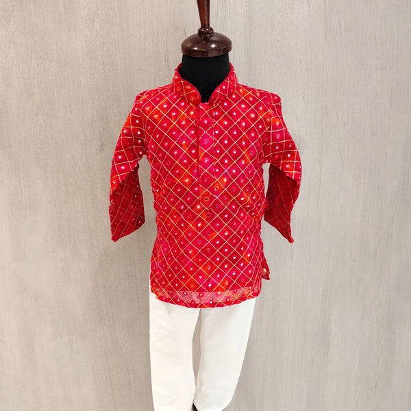 Red patterned shirt on a mannequin against a beige background
