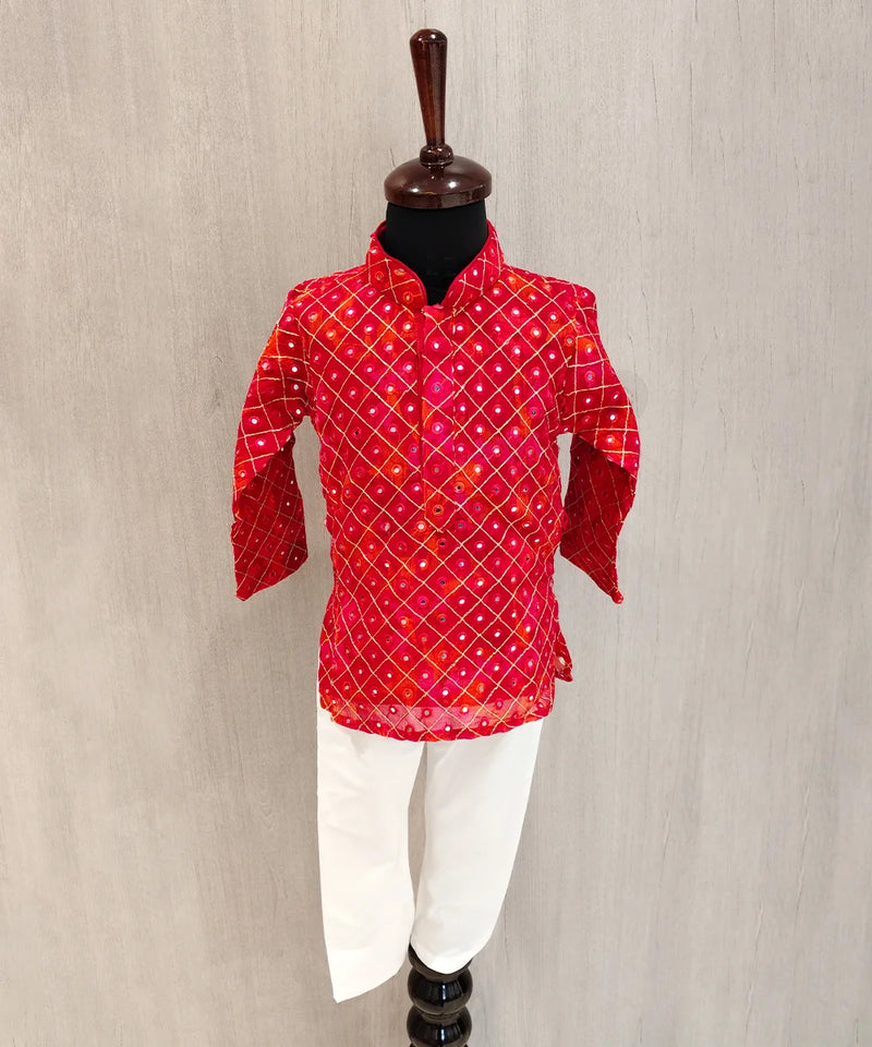 Red patterned shirt on a mannequin against a beige background
