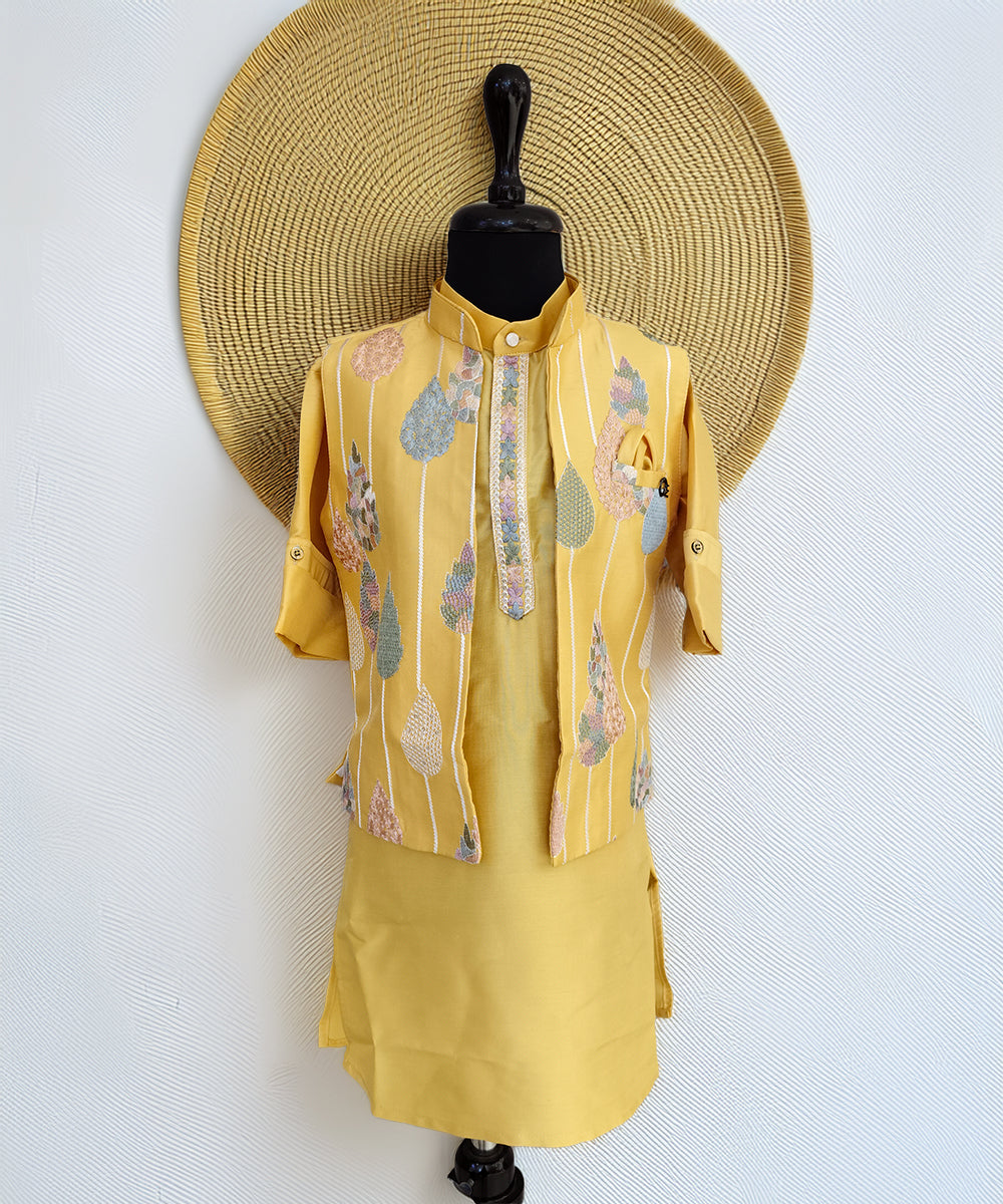 Yellow outfit with floral patterns on a mannequin against a white background