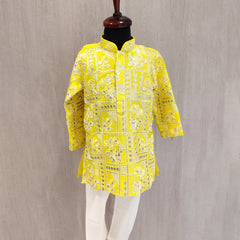 Yellow patterned shirt on a mannequin against a gray background