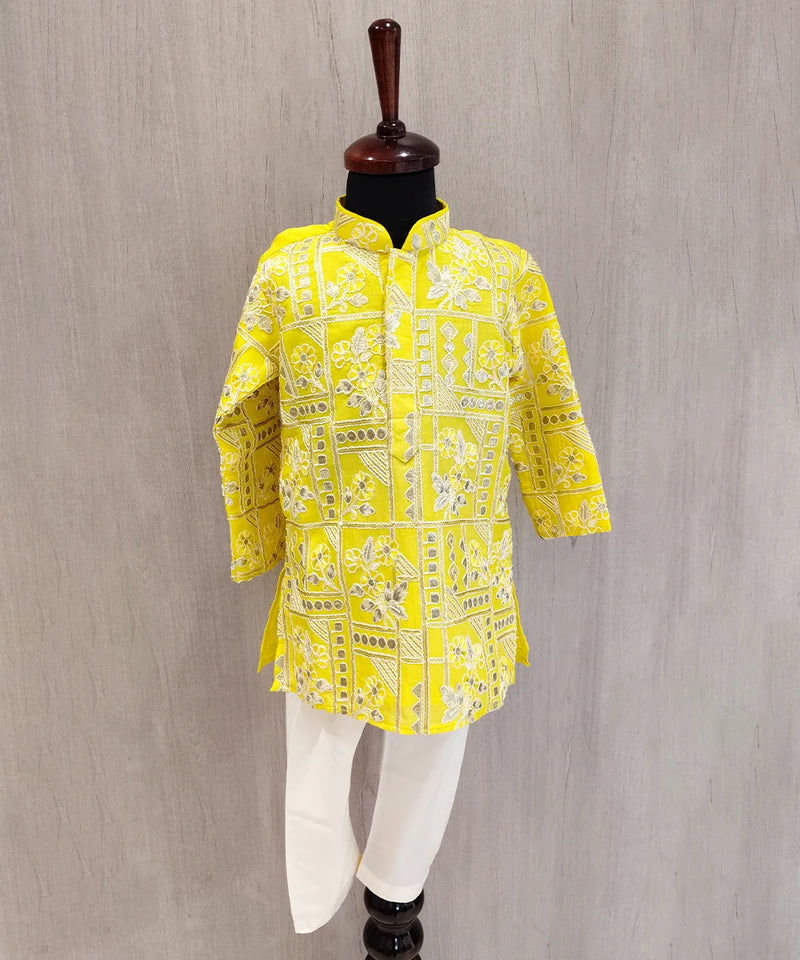 Yellow patterned shirt on a mannequin against a gray background