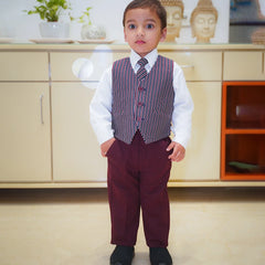 The picture shows the boy without the blazer and wearing just the striped waist coat with white shirt and maroon pant