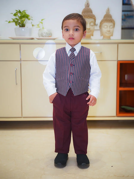 The picture shows the boy without the blazer and wearing just the striped waist coat with white shirt and maroon pant