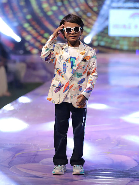 Child model on a fashion show runway wearing a colorful printed blazer