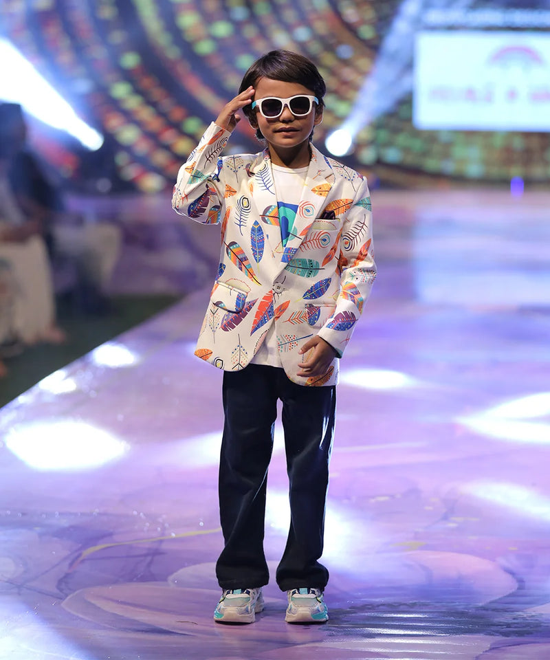 Child model on a fashion show runway wearing a colorful printed blazer