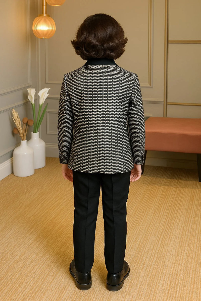 Person wearing a patterned jacket and black pants in an indoor setting.