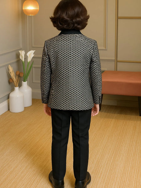 Person wearing a patterned jacket and black pants in an indoor setting.