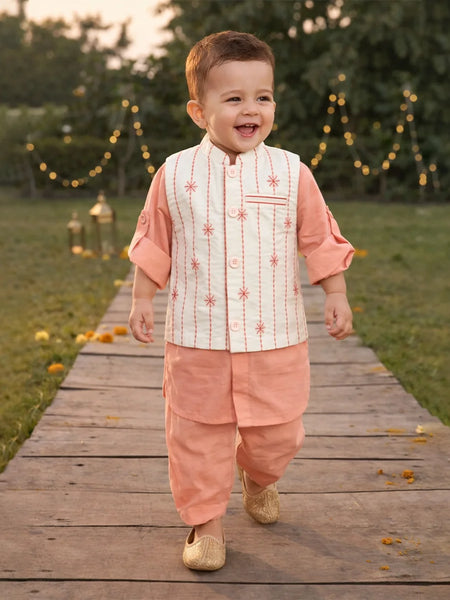 Child in traditional outfit walking on a wooden path with decorative lights in the background
