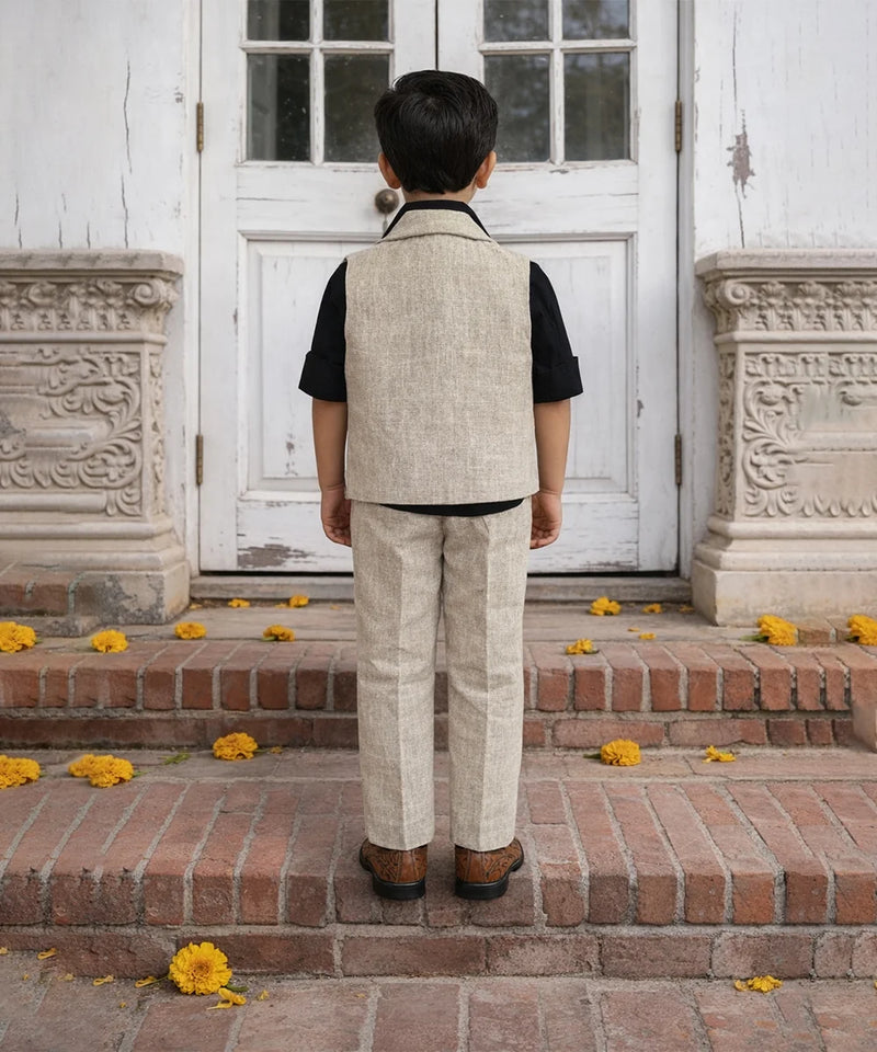 Person wearing a beige vest and pants standing on steps with decorative flowers.
