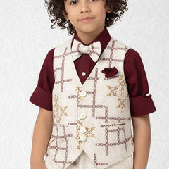 Child wearing a maroon shirt with a white vest and bow tie against a light background