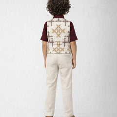 Child wearing a patterned vest over a shirt with beige pants on a white background