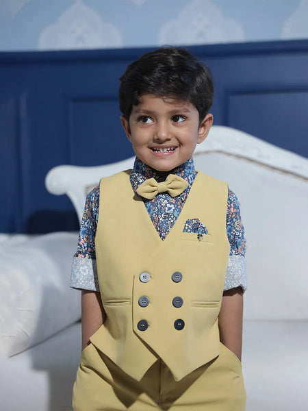 blue printed shirt with beige waist coat and a bow paired with beige pants for boys for parties & wedding