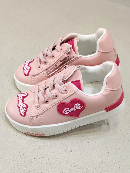 Pink sneakers with a heart-shaped Barbie logo on a light background
