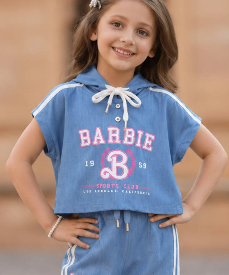 Young girl wearing a blue Barbie sports club outfit with a hood.