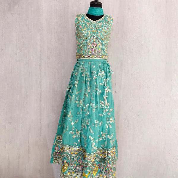Teal dress with floral patterns on a mannequin against a plain background