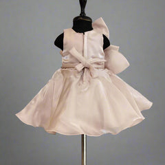 Blush pink dress on a mannequin against a plain background