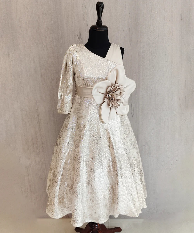 White lace dress with a floral detail on a mannequin against a neutral background