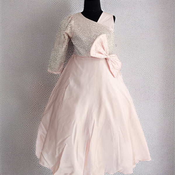 Mannequin wearing a dress with a textured top and pink skirt against a textured gray background