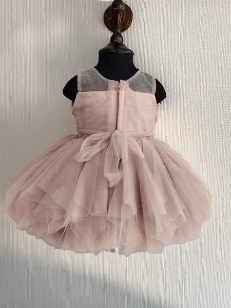 Pink dress on a mannequin against a neutral background