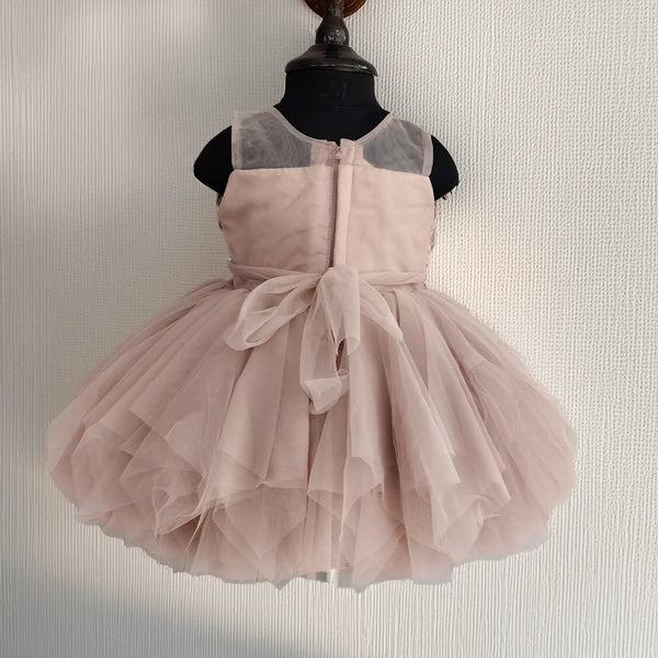 Pink dress on a mannequin against a neutral background