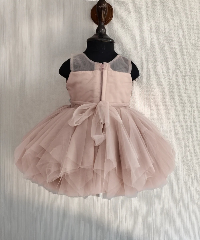 Pink dress on a mannequin against a neutral background