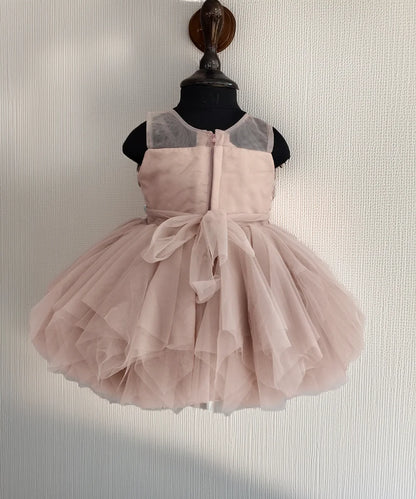 Pink dress on a mannequin against a neutral background