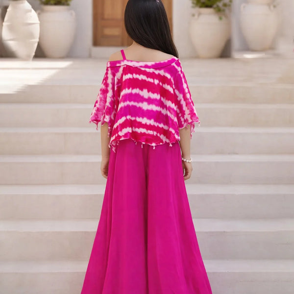 Person wearing a pink and white striped top with a long pink skirt on a staircase.