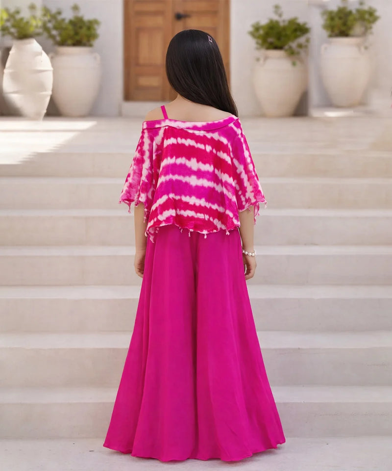 Person wearing a pink and white striped top with a long pink skirt on a staircase.