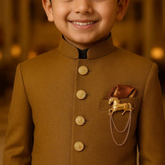 Young boy wearing a brown traditional outfit with gold buttons and a decorative patch.