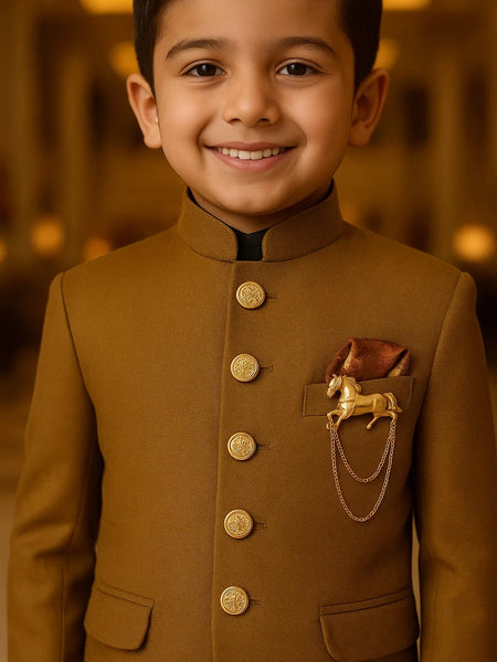 Young boy wearing a brown traditional outfit with gold buttons and a decorative patch.