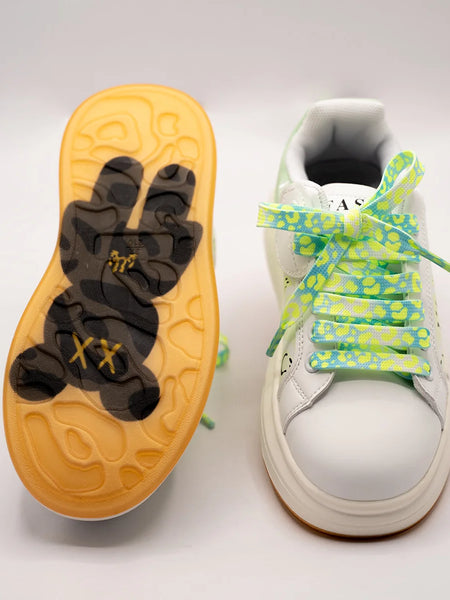 Close-up of trendy girls' sneakers with smile print and bold neon laces, perfect for playful outings in Jaipur

