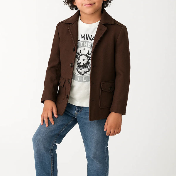 Child wearing a brown coat, white t-shirt with graphic design, blue jeans, and yellow shoes on a white background